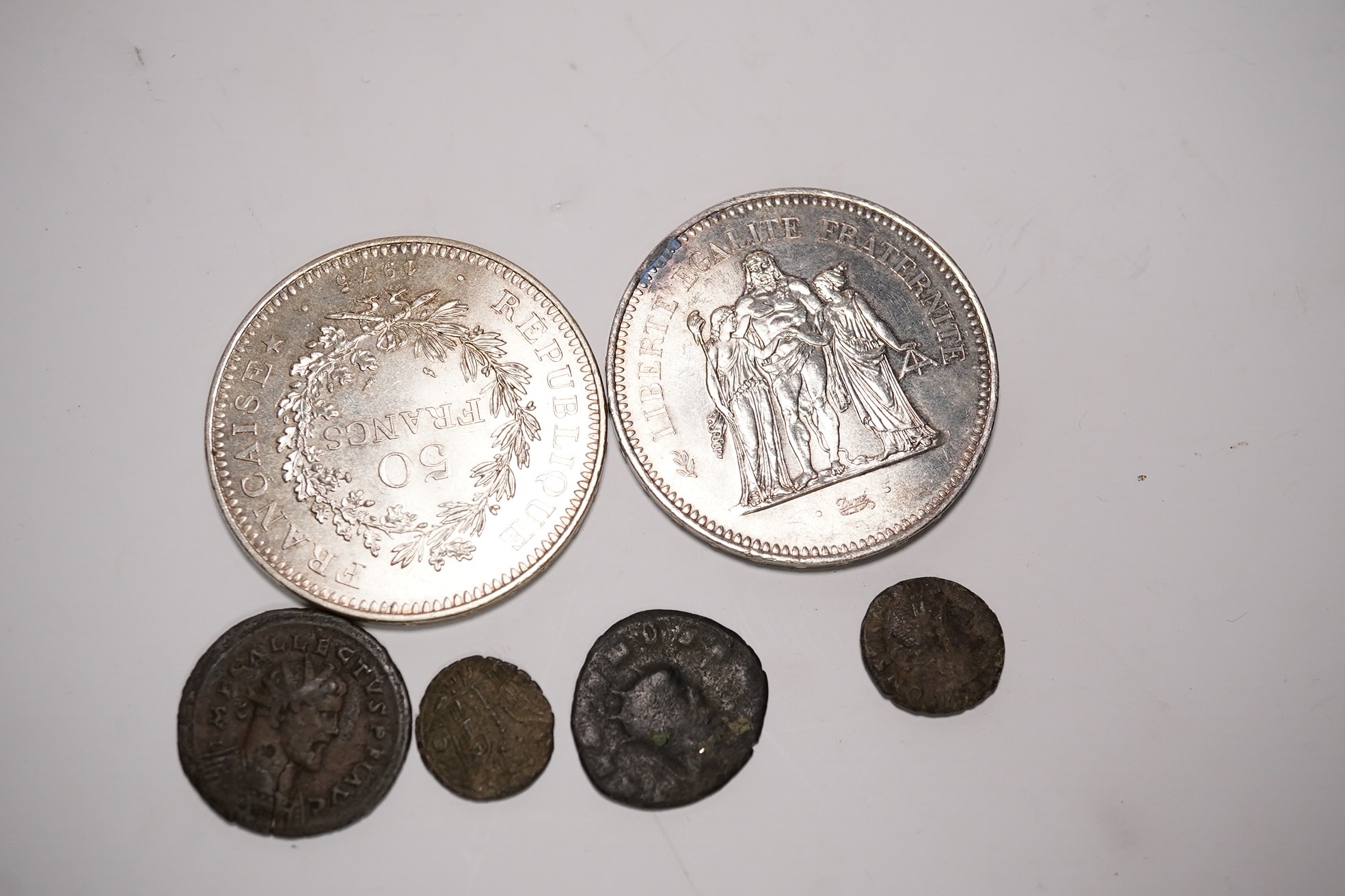Two fifty Franc silver coins and four Roman AE coins. Condition - as per images